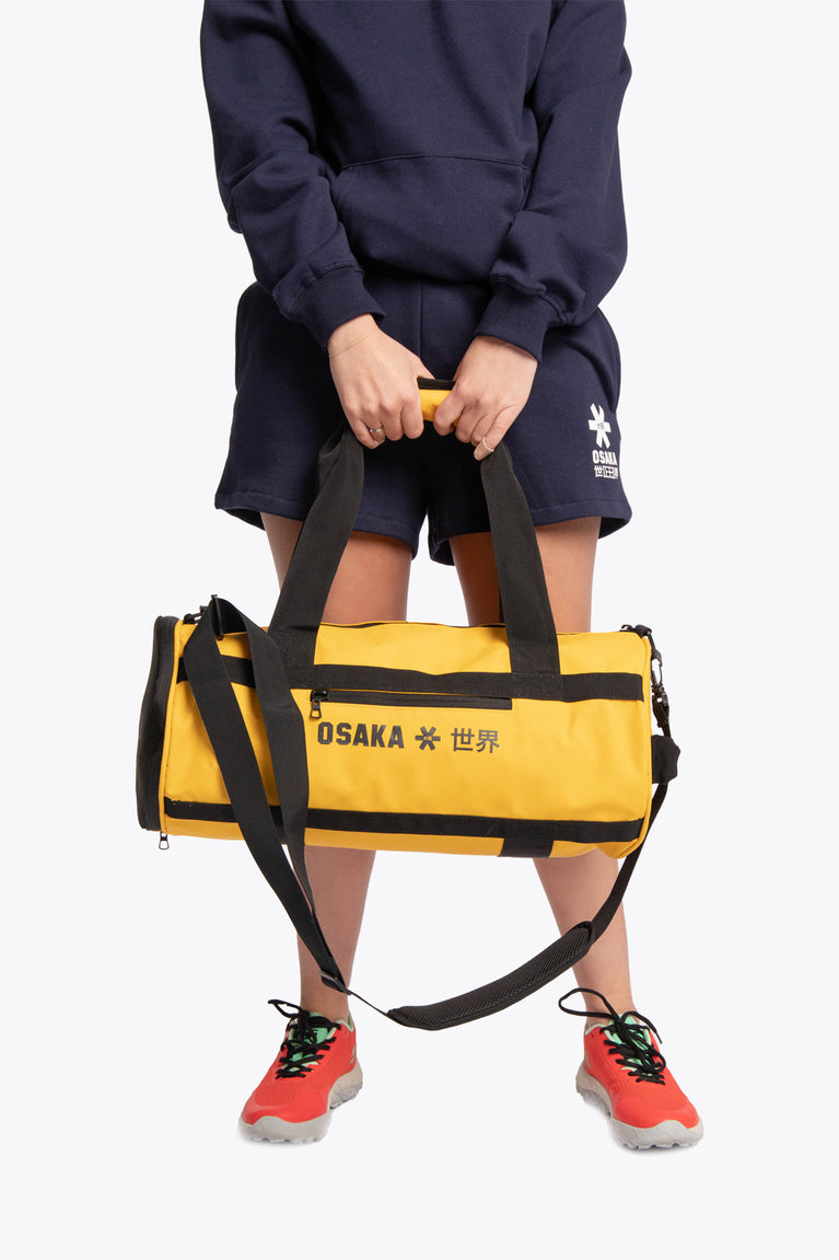 Honey comb pro tour duffle bag to transport your needs to your favourite sportsplace, stylish. person holding front view